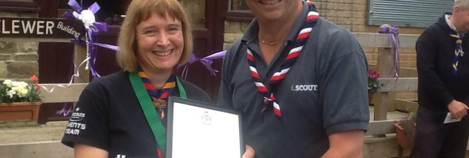 Alison Walton, Deputy District Commissioner receives the Medal of Merit from Way...